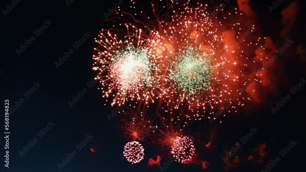Red fireworks are visible from above, which explode with large red