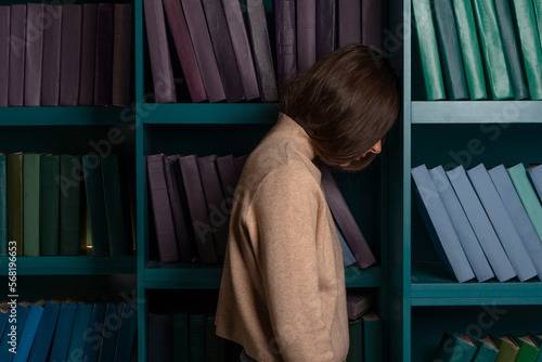 Exam stress, tired girl on the background of bookshelves. Natural sciences. A large amount of information. Student in the library, laconic minimalistic style