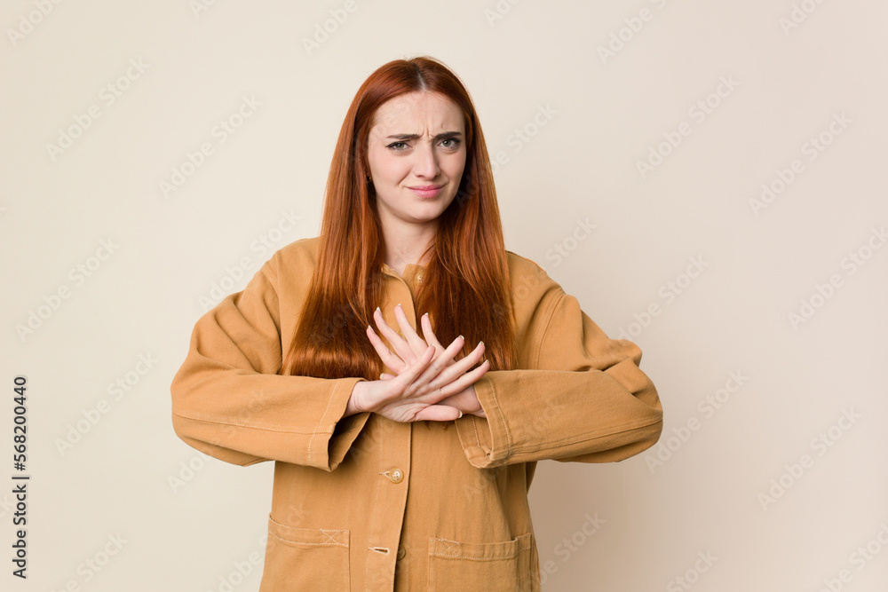 Young red hair woman isolated doing a denial gesture Young red hair woman isolated doing a denial gesture