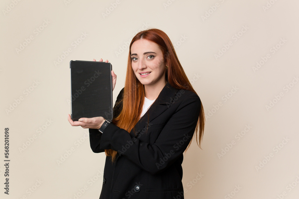 Young red hair business woman holding a tablet isolated Young red hair business woman holding a tablet isolated