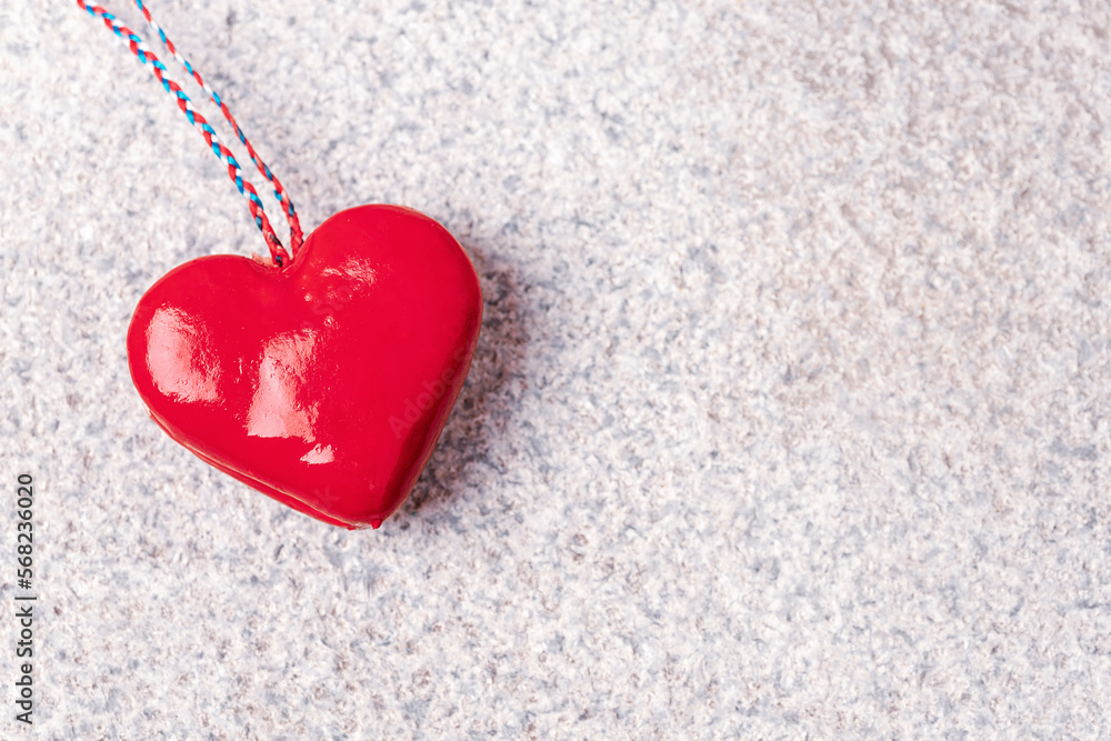 Red toy heart on granite stone textured background. Valentines day concept. Top view, flat lay, copy space Red toy heart on granite stone textured background. Valentines day concept. Top view, flat lay, copy space