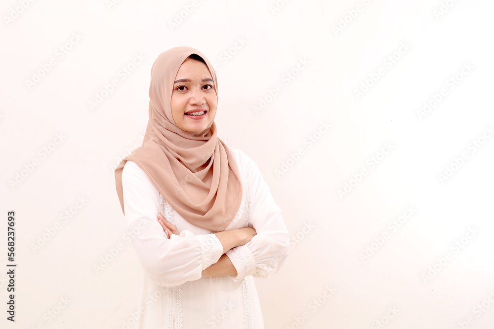 Portrait of young asian muslim woman standing with folded hands. Isolated on white background Portrait of young asian muslim woman standing with folded hands. Isolated on white background