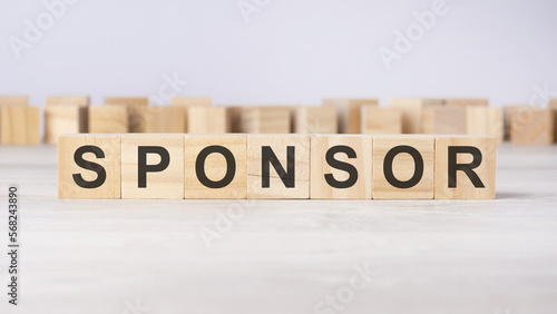 word sponsor inscribed on wooden cubes lying on a light table. economy and investments concept.