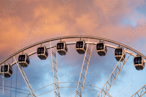 Ferris wheel with beautiful sunset clouds in the background.