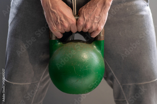 Person getting fit using kettlebell weights