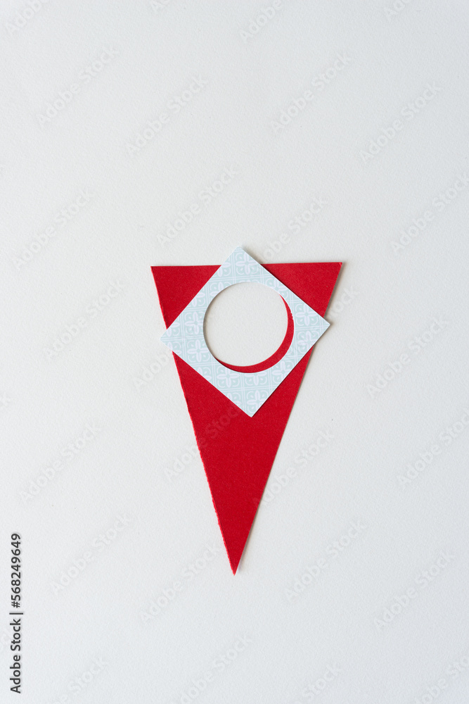 red paper arrow (pointing down) and square tile with hole red paper arrow (pointing down) and square tile with hole
