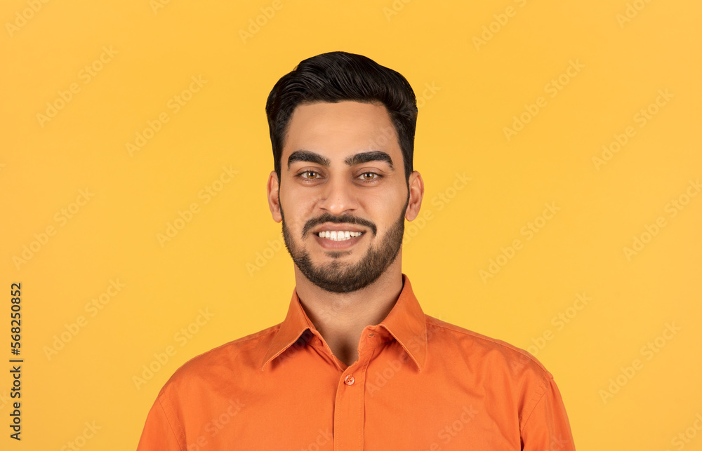 Closeup portrait of handsome young middle eastern man smiling at camera