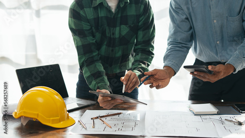 Close up of hands working brainstorming and measuring for cost estimating on paperworks and floor plan drawings about design architectural and engineering for houses and buildings..