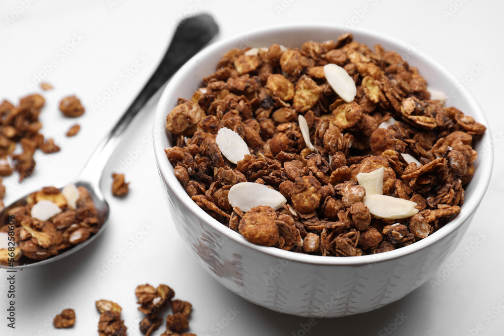 Bowl of tasty granola with nuts and dry fruits on white marble table Bowl of tasty granola with nuts and dry fruits on white marble table