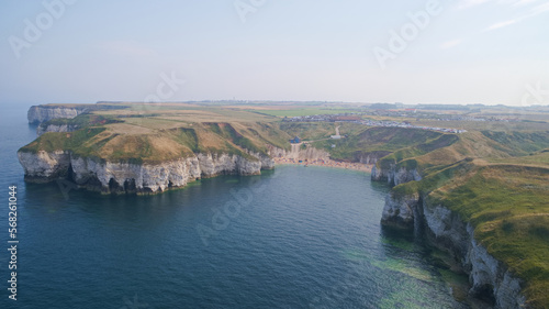 North Landing bay on the East Yorkshire coast of the United Kingdom showing the small beach and the craggy limestone chalk cliffs jutting out into the sea.
