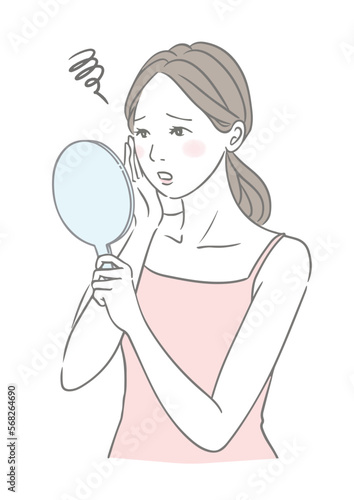 お肌のトラブルに困る女性 手鏡を見る女性