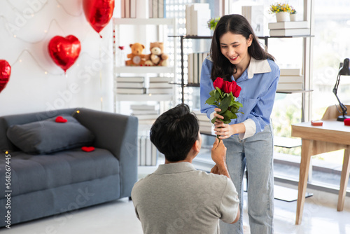 Couple in love hugging in the bedroom with rose and gift Valentine's Day concept.