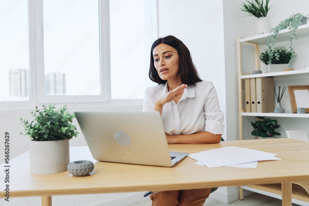 Woman business freelancer via video link via laptop shows papers online for startup, smile and happiness in employee chat, training online