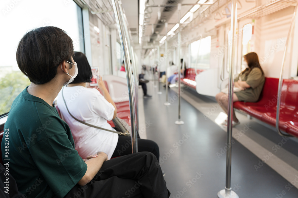 Asian young boy sitting on the chair  in the train.Public transport concept.