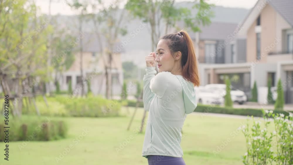 Asian woman stretching her body warm up before workout outside. New normal workout. Girl in sportswear exercises outside at morning sunrise for health and wellbeing. slow motion b roll. Asian woman stretching her body warm up before workout outside. New normal workout. Girl in sportswear exercises outside at morning sunrise for health and wellbeing. slow motion b roll.