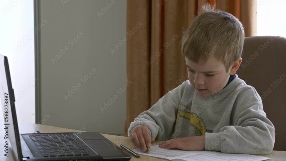 Kid Erases Mistakes with Rubber Eraser. Little Boy Distance Remote Study Music Online on Laptop at Home Sitting at Desk. Slow motion 4K Kid Erases Mistakes with Rubber Eraser. Little Boy Distance Remote Study Music Online on Laptop at Home Sitting at Desk. Slow motion 4K