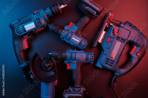 Set of new power tools isolated on a black background, drill, puncher, electric saw, jigsaw, circular saw photo