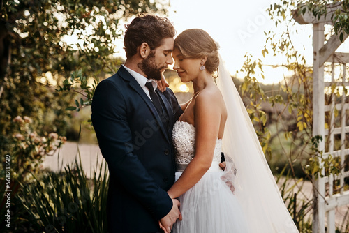 Wedding, love and bride with groom in garden for marriage, ceremony celebration and commitment. Romantic partners, trust and bridal couple hug, embrace and happy for romance, calm and peace in park