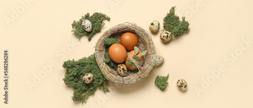 Nest with Easter eggs and moss on light background
