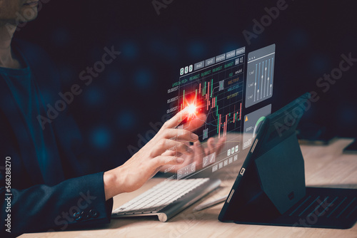 Hand of Businessman or trader is touching a growing virtual hologram stock on smartphone, planning and strategy, Stock market, Business growth, progress or success concept. invest in trading.