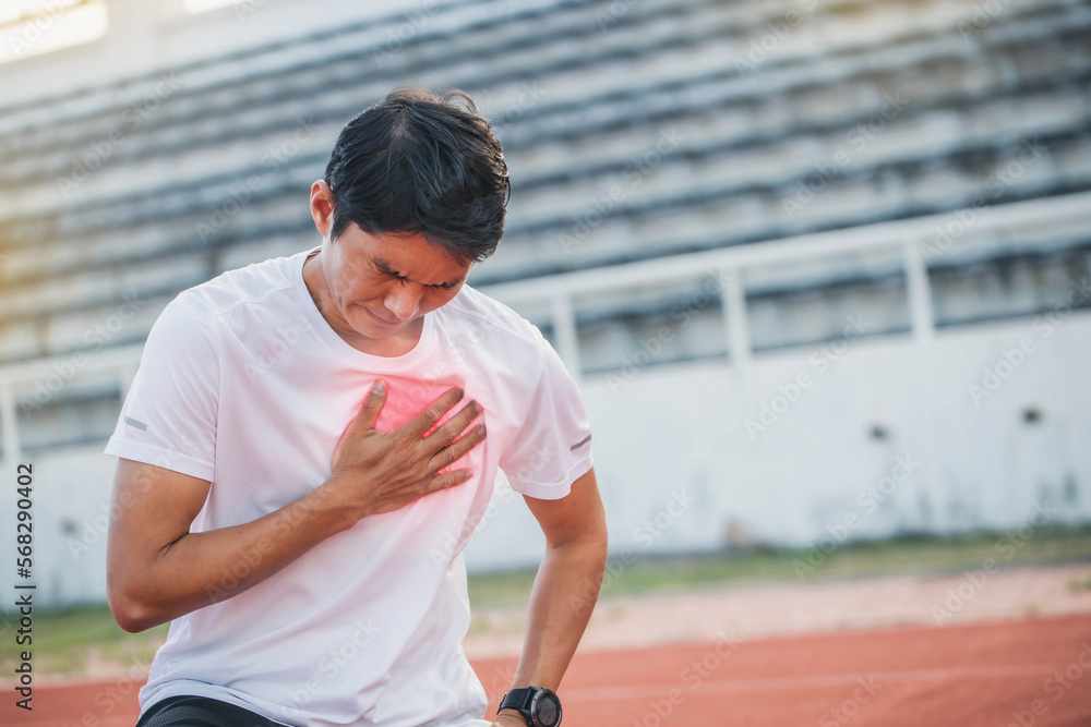 Man runner athlete chest injury and pain. sport man having chest pain after running in the park , heart attack. Asian cardiac arrest running young man heart attack in park.