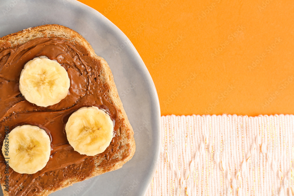 Plate of tasty toast with hazelnut butter and banana on color background, closeup Plate of tasty toast with hazelnut butter and banana on color background, closeup