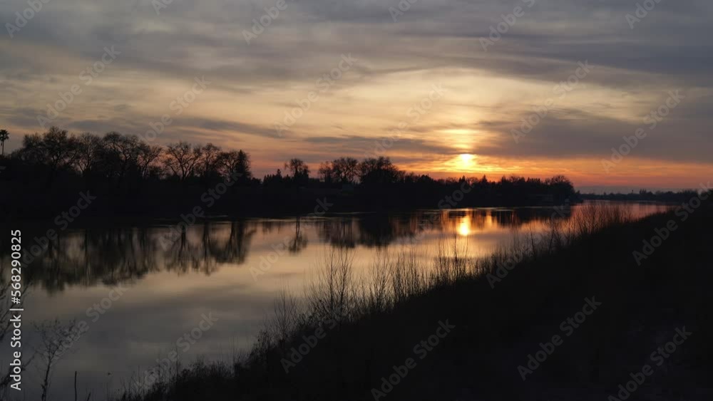 Timelapse on sacramento river levee at sunset in winter Timelapse on sacramento river levee at sunset in winter