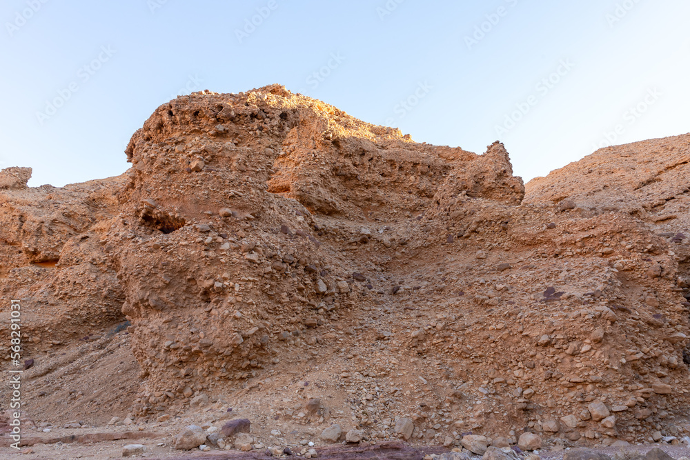 Fototapeta premium Fantastically beautiful landscape in the national nature reserve - Red Canyon in the rays of the setting sun, near the city of Eilat, in southern Israel