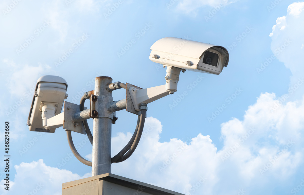 Modern public CCTV camera with clear sky background. Recording cameras for monitoring all day and night. Concept of surveillance and monitoring with copy space. Modern public CCTV camera with clear sky background. Recording cameras for monitoring all day and night. Concept of surveillance and monitoring with copy space.