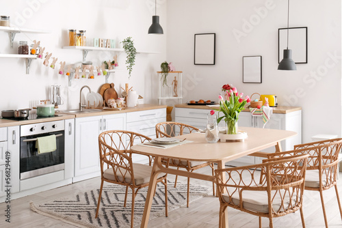 Interior of kitchen decorated for Easter celebration with dining table and counters