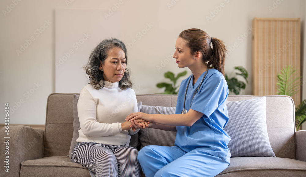 Happy patient is holding caregiver for a hand while spending time together. Elderly woman in nursing home and nurse. Happy patient is holding caregiver for a hand while spending time together. Elderly woman in nursing home and nurse.