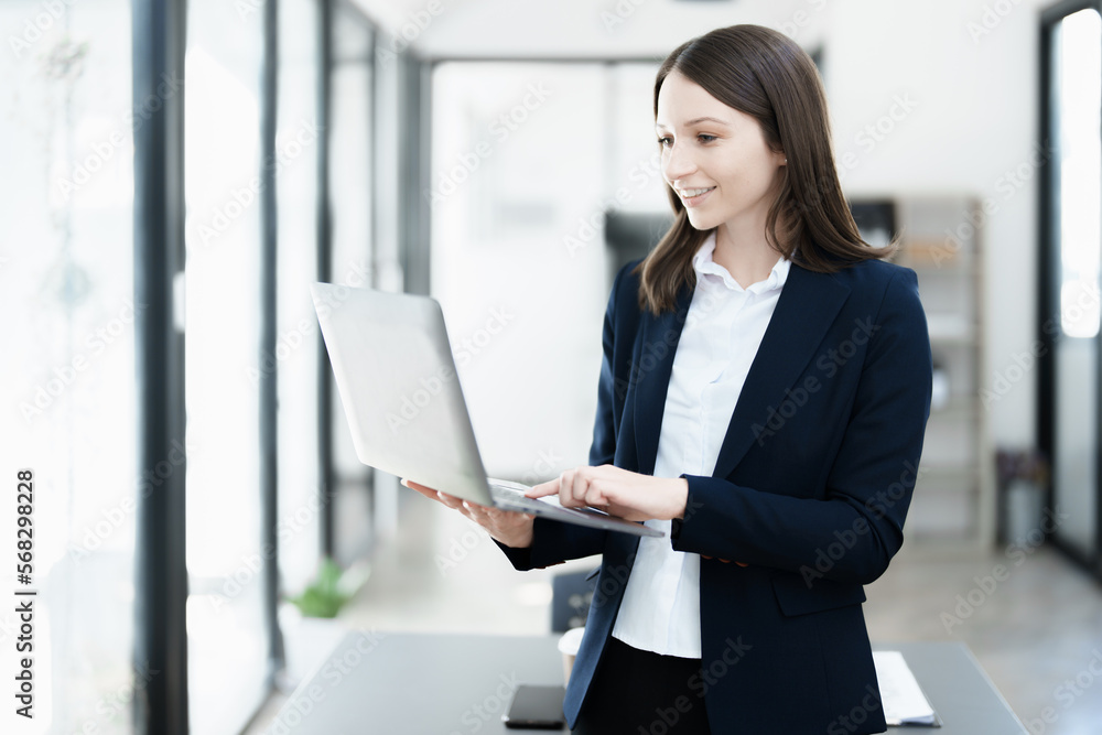 Excited businesswoman using computer laptop while in office, business concepts. Excited businesswoman using computer laptop while in office, business concepts.