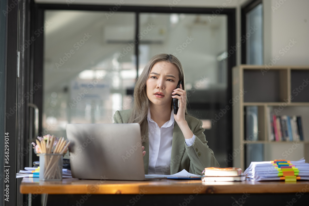 custom made wallpaper toronto digitalAsian businesswoman are stressed and tired from work sitting at desk in the office, feeling sick at work, stress from work. 