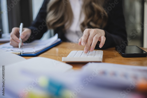Business woman hands working on calculator, Accountant and finance concept.