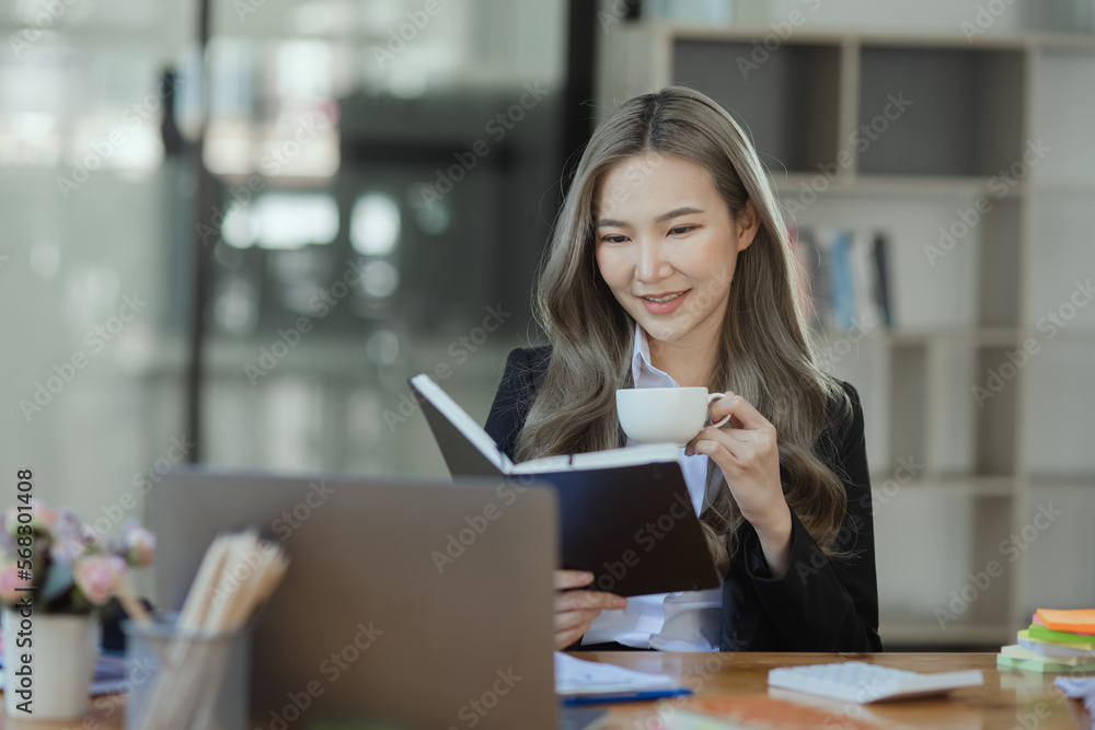 Cheerful asian businesswoman working at table office. Cheerful asian businesswoman working at table office.