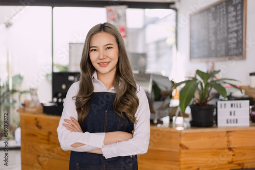 Asian Young business woman cafe owner. Successful owner standing at cafe shop. 