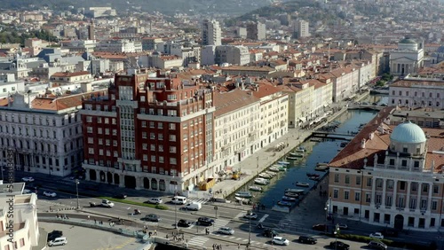 aerial drone shot of trieste city center from the sea on the canal grande ponterosso with hills in background photo