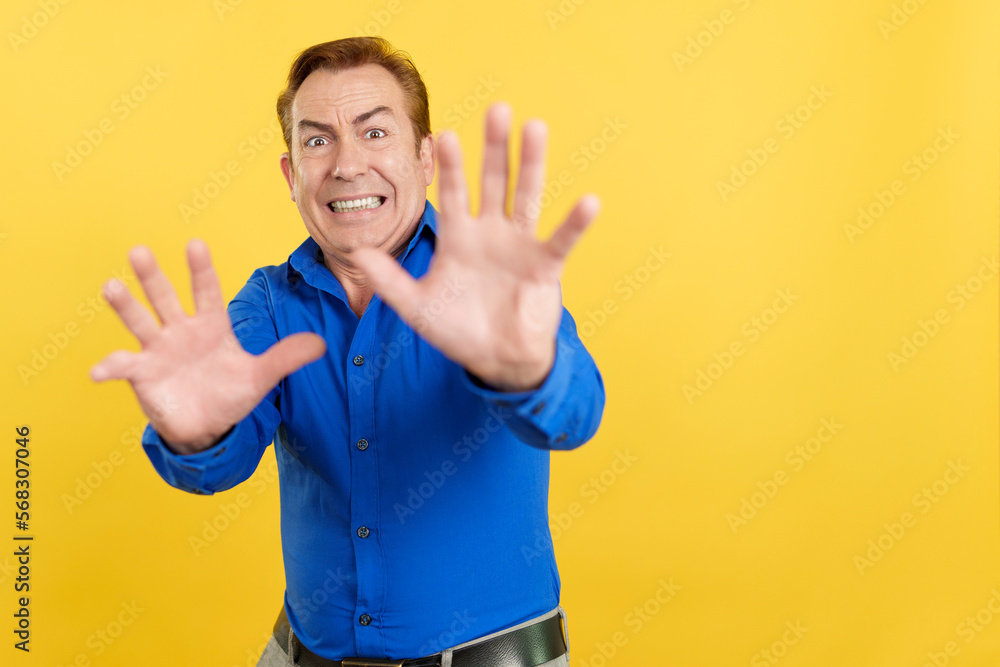 Mature man gesturing with the hands in fear Mature man gesturing with the hands in fear