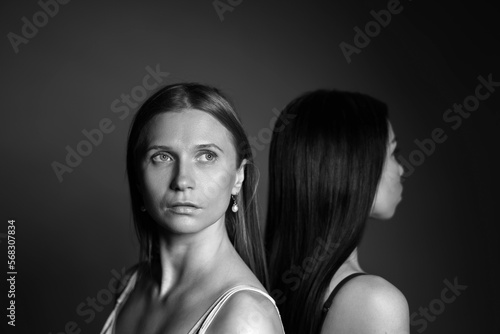 Black and white portrait of two beautiful women. A serious look, a shot on the shoulders.