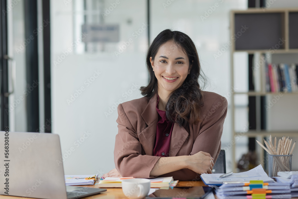 Asian businesswoman working on laptop computer sitting at desk in office, business finance and accounting, business online training concept. Asian businesswoman working on laptop computer sitting at desk in office, business finance and accounting, business online training concept.