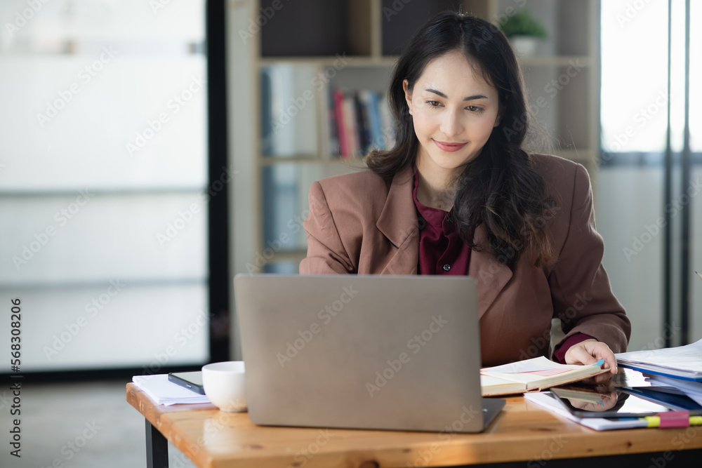 Happy smiling young asian business woman holding digital tablet standing in the office, Company worker woman. Happy smiling young asian business woman holding digital tablet standing in the office, Company worker woman.