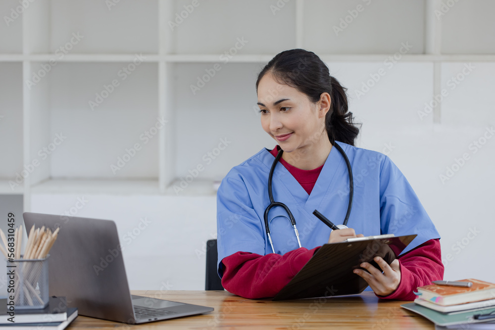 Happy smiling doctor woman working on laptop at desk in hospital, Professional doctor medical and healthcare. Happy smiling doctor woman working on laptop at desk in hospital, Professional doctor medical and healthcare.