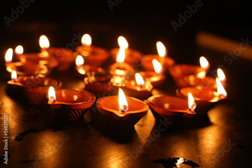Beautiful diwali lighting, selective focus, Clay diya lamps lit during Diwali Celebration.