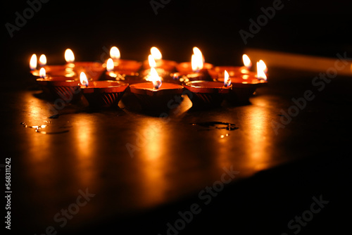 Beautiful diwali lighting, selective focus, Clay diya lamps lit during Diwali Celebration.