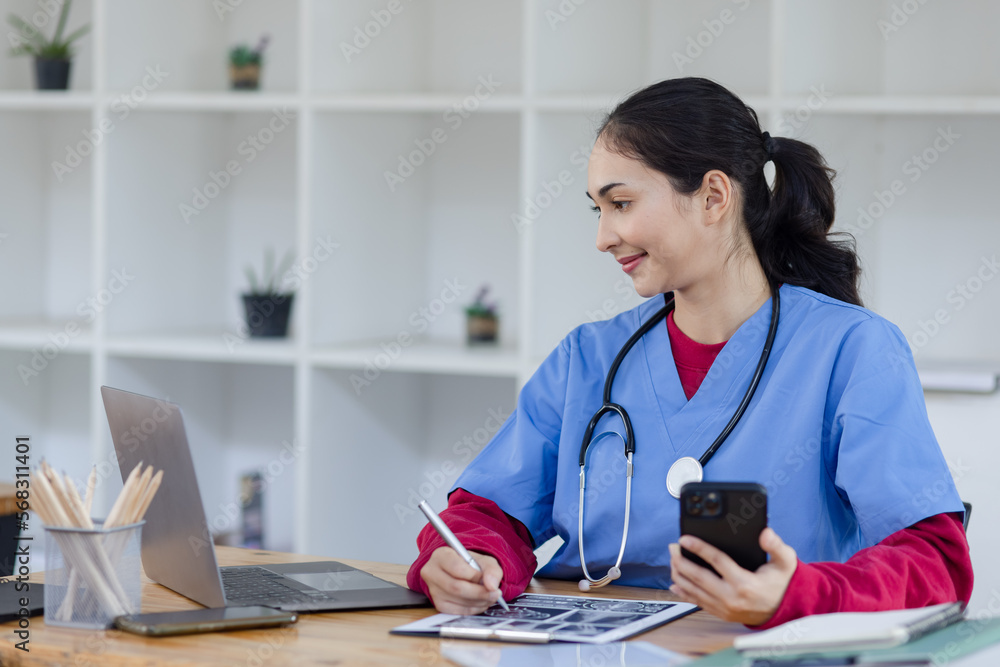 Happy smiling doctor woman working on laptop at desk in hospital, Professional doctor medical and healthcare. Happy smiling doctor woman working on laptop at desk in hospital, Professional doctor medical and healthcare.