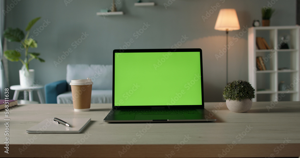Copy space template - close up shot of modern laptop with chroma key green set up for work in living room at home - technology, design concept 