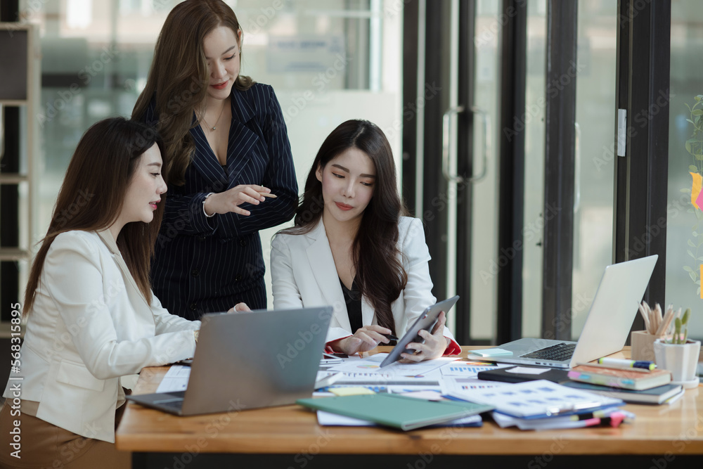 Group of young Asian business woman teamwork and presenting new projects in the office. Group of young Asian business woman teamwork and presenting new projects in the office.