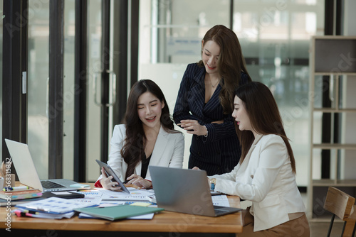 Group of young Asian business woman teamwork and presenting new projects in the office.