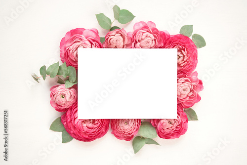 Layout for text placement. Space for text. Love letter. white card with white paper envelope mock up. Petals of flowers, roses and ranunculus. Valentine's day romantic background . 