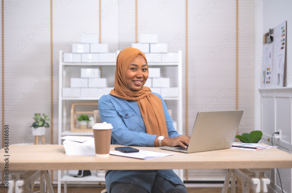 Smiling African female business owner using digital tablet and talking on the phone .Online shopping and start up concept. Smiling African female business owner using digital tablet and talking on the phone .Online shopping and start up concept.